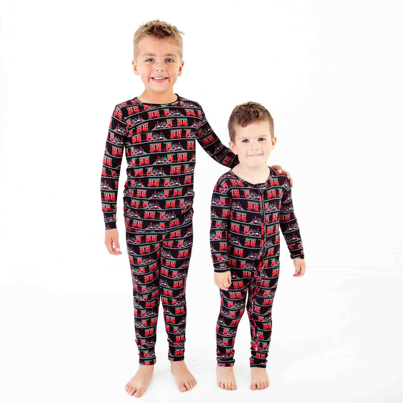 Matching brothers in Holiday train print pajamas. 